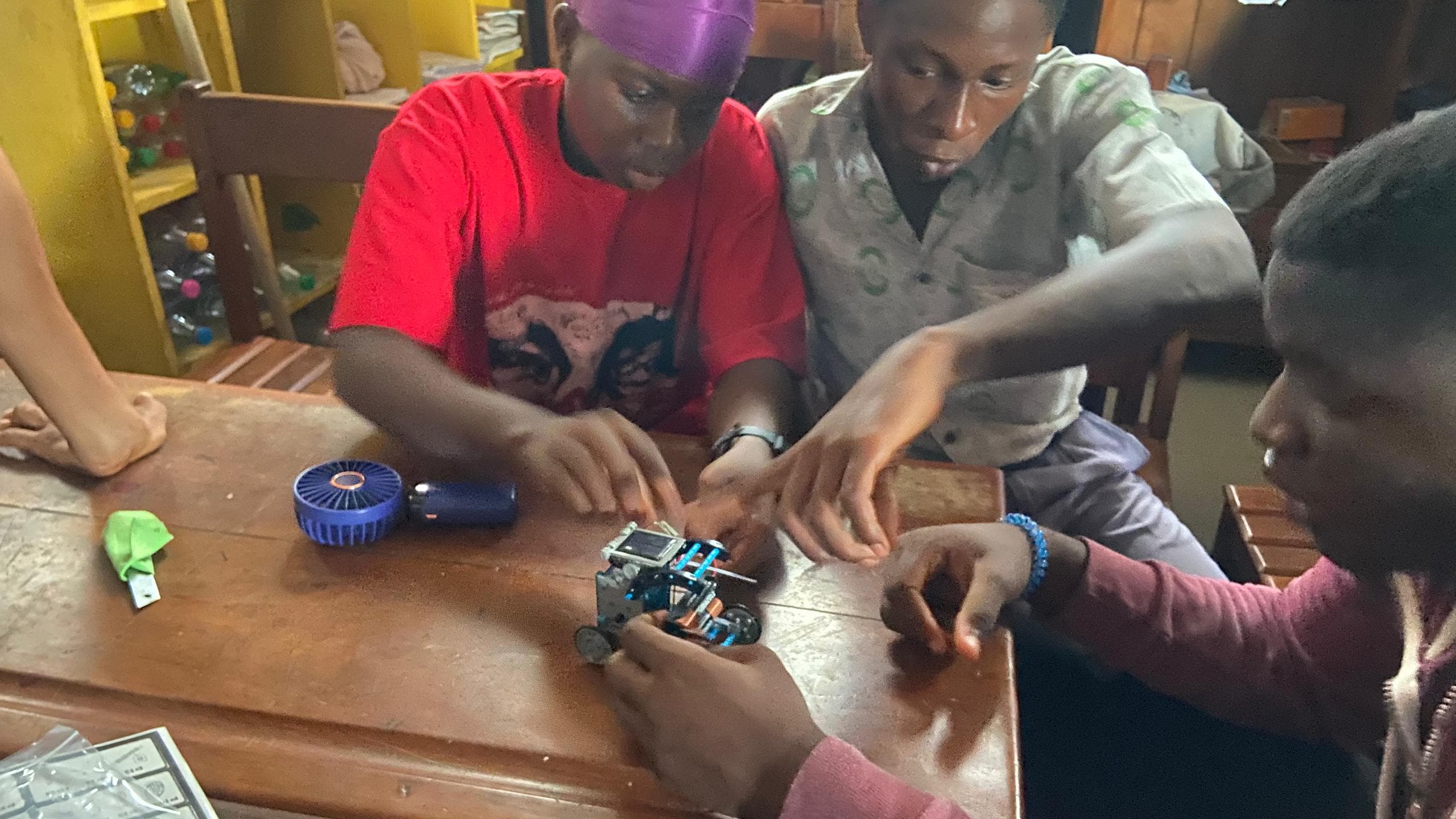 Young people building and testing robots at a Giiyo Tech workshop