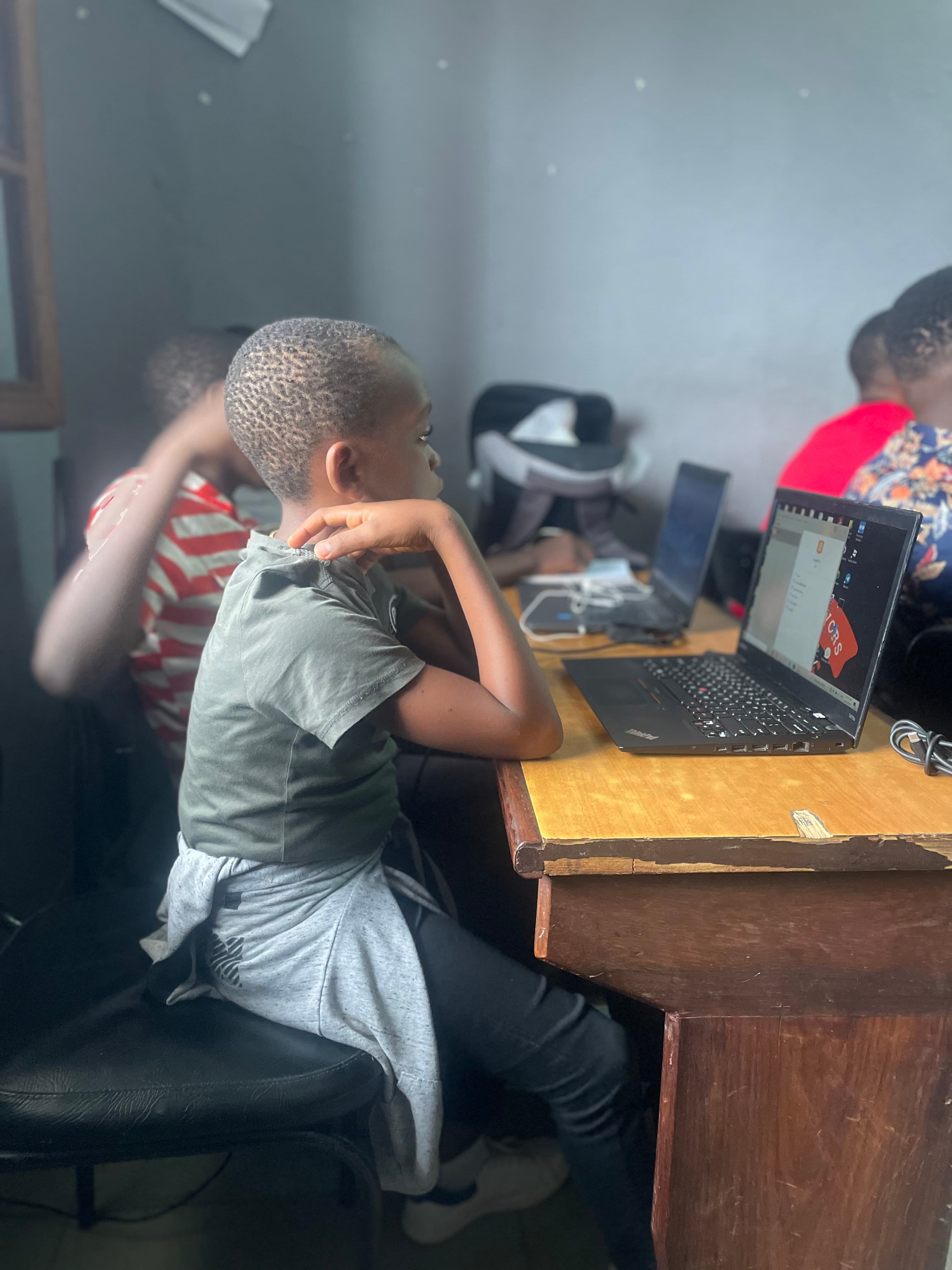 A young student focused on his laptop